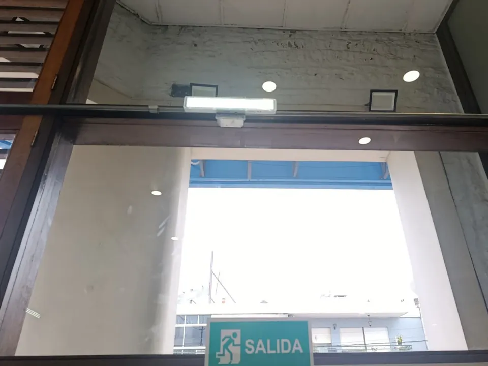Luminaria de emergencia instalada sobre el acceso principal de una sucursal en Artigas